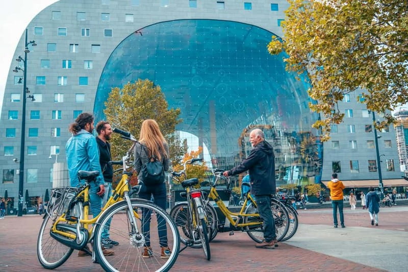 Discover Rotterdam: Classic Highlights Bike Tour by a Local - The riverfront begins with Hotel New York and Erasmus Bridge