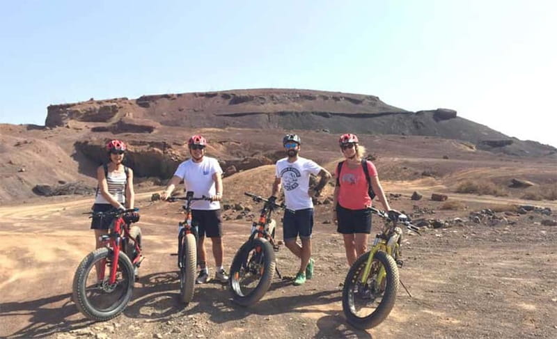From Corralejo: Fuerteventura Guided E-Bike/E-scooter Tour - Calderón Hondo requires a walk