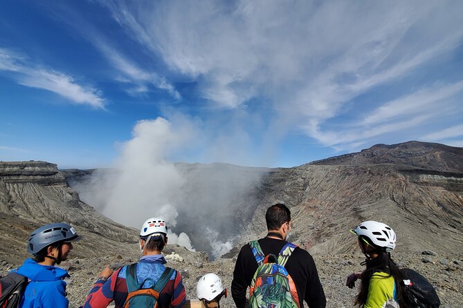 Private E-MTB guided cycling around Mt. Aso volcano & grasslands - The descent and the caldera opening below