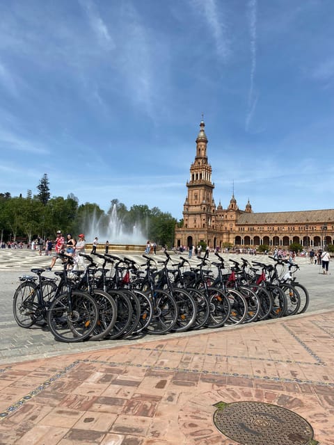 Seville: Highlights City Bike Tour - Crossing into Triana for tile and flamenco
